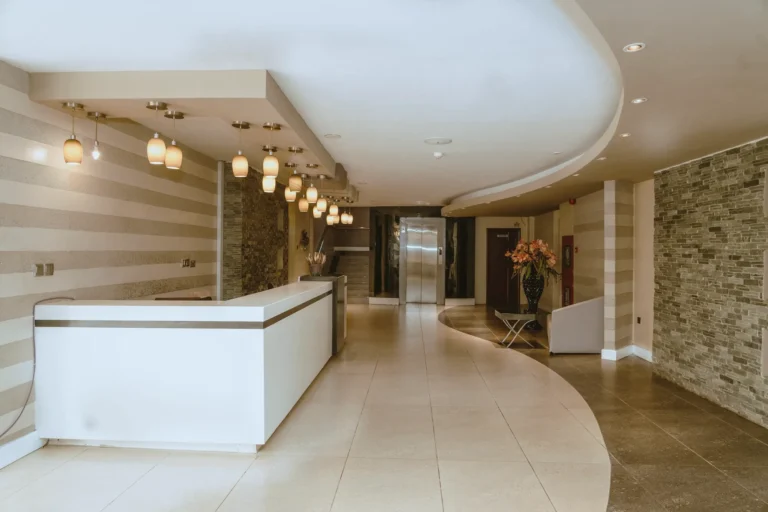 Reception area with a curved floor inlay and pendant lamps